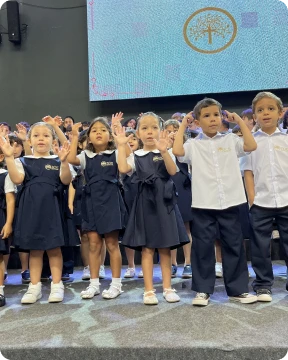 Alunos da Zoe reunidos no palco em celebração